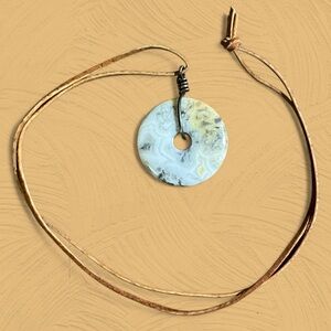 Crazy Lace Agate Pi Disc Donut Pendant on Brown Leather Cord